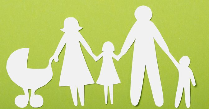 Closeup of paper family on green background