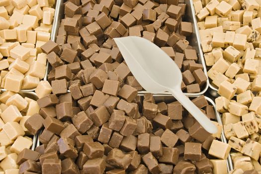 Brown and yellow toffee cubes in a market