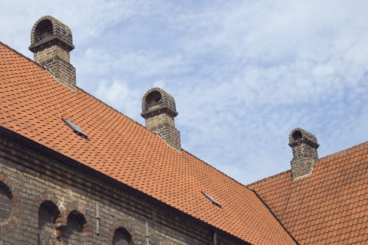 Roof of an old monastery against blue sky