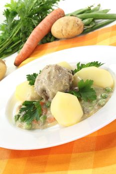 cooked meatballs with capers, peas and carrots