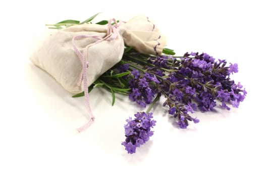 Lavender bag with purple flowers and green leaves on a light background