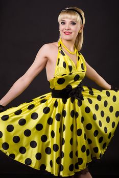 Young dancer woman in yellow dress.