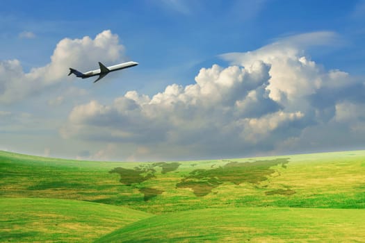 Airplane flying over green field with blue sky