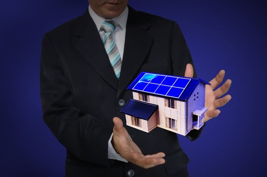 Business Man holding house or home