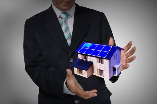 Business Man holding house or home