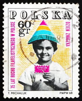 POLAND - CIRCA 1968: a stamp printed in the Poland shows Child Holding Symbolic Stamp, 75 Year of Polish Philately, circa 1968