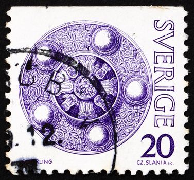 SWEDEN - CIRCA 1975: a stamp printed in the Sweden shows Shield Buckle, Treasures from Vendel Period, circa 1975