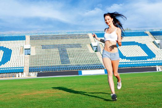 the girl running on the football field on the lawn.