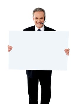 Help desk executive showing white billboard wearing headsets