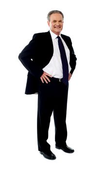 Senior businessman posing with hands on his waist, full length portrait