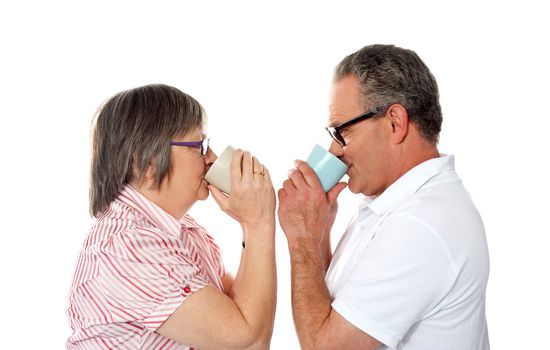 Aged love couple drinking coffee and looking at each other