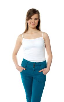 Cute fashionable girl posing in style with hands in pocket over white background