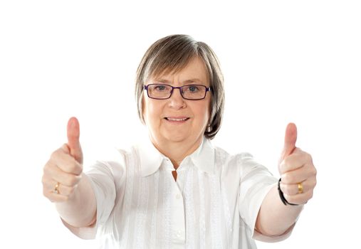 Female gesturing double thumbs up to camera isolated over white
