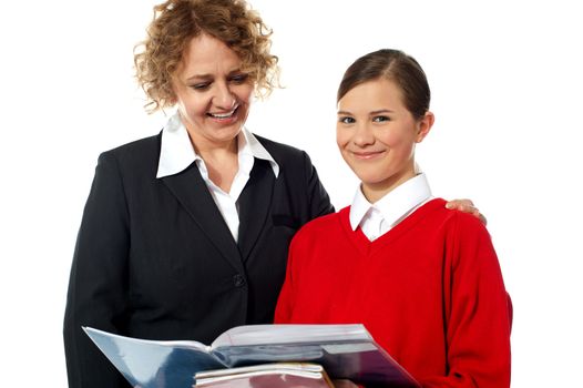 Teacher and student posing together against white background