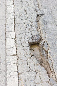 Asphalt surface because it is very old.