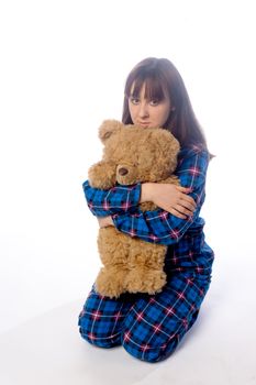 A girl and a big soft toy on white
