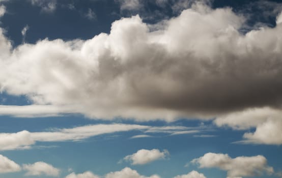 Cumulus clouds threatening rain with blue sky background