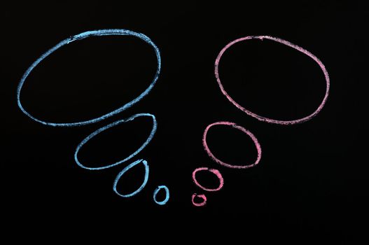 Chalk drawing of speech bubbles on a blackboard