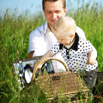 father and son in the grass