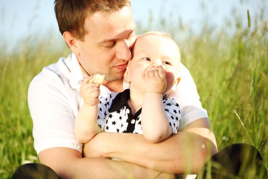 father and son in green grass