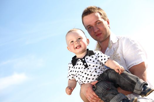 father and son in blue sky