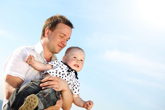 father and son in blue sky