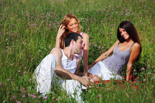 friends and dog in green grass field