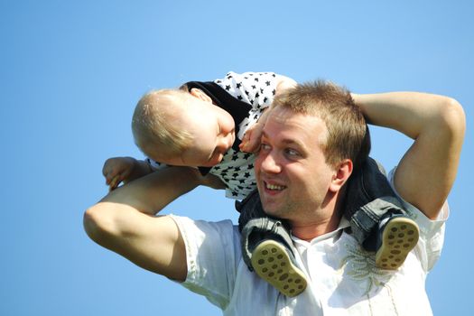 father and son in blue sky