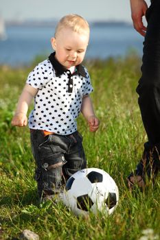 little boy play soccer outdoor