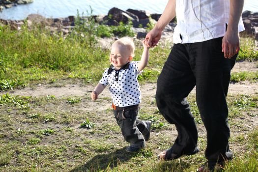father and son walking on grass