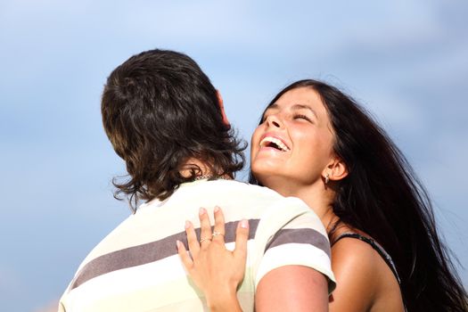 man and woman hug sky on background