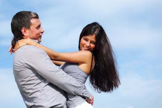 man and woman hug in the sky