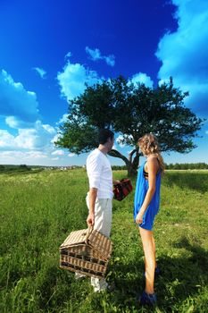 man and woman on picnic in green grass