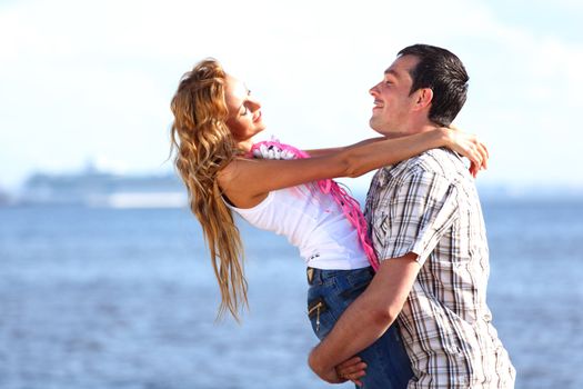 man and woman hug in the sky and sea on sea