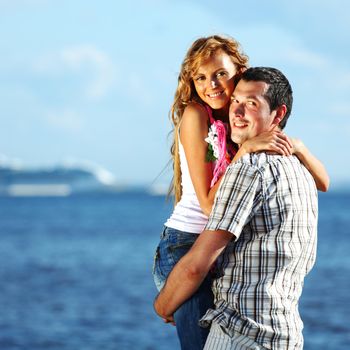 man and woman hug in the sky and sea on sea