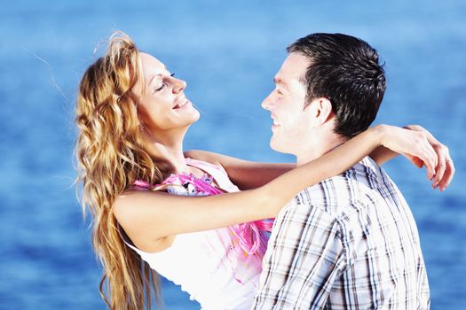man and woman hug in the sky and sea on sea