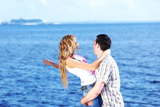 man and woman hug in the sky and sea on sea