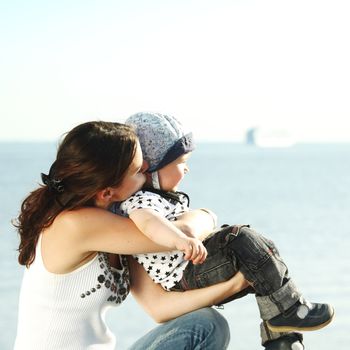 happy mother and son on picnic near sea