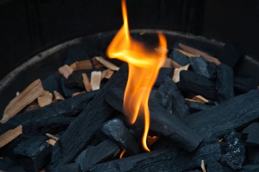 Flame and charcoal in a bbq grill