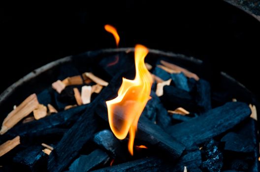 Flame and charcoal in a bbq grill