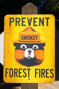 Illinois, USA - Septemeber 12, 2010: Smokey Bear is a character created by the United States Forest Service intended to educate the public concerning the prevention of wildfires.  Smokey Bear is seen here on an older sign at Castle Rock State Park Campground in Illinois reading Prevent Forest Fires.