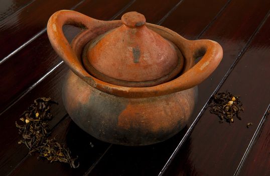 Old teapot on the wood background
