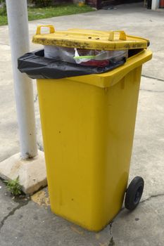 close up of yellow full trash can