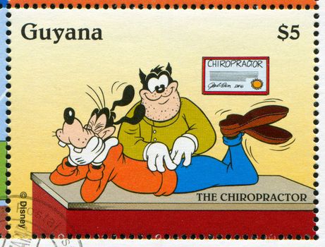 GUYANA - CIRCA 1995: stamp printed by Guyana, shows Walt Disney characters, Goofy, Chiropractor, circa 1995