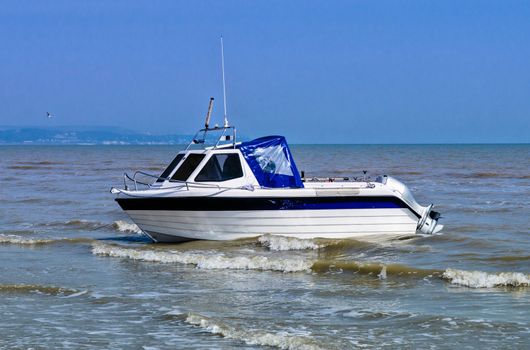 Small leisure fishing boat near the shore on the Kent coast