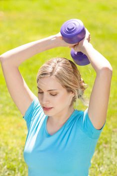 Young sport woman lift weight work out outdoors