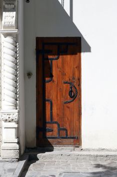 Closeup of white wall with nice old wooden door