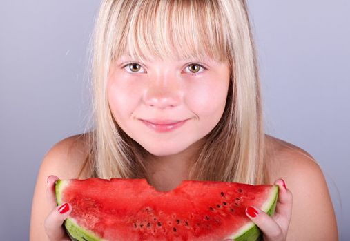 Beautiful  girl eating a juicy slice of watermelon