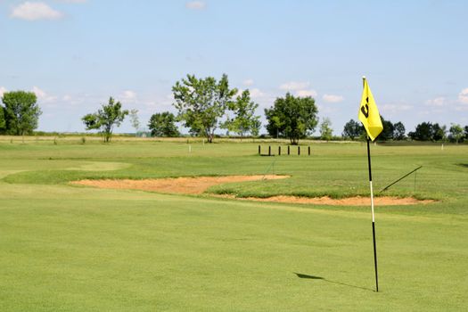 field with yellow golf flag