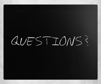 "Questions?" handwritten with white chalk on a blackboard.